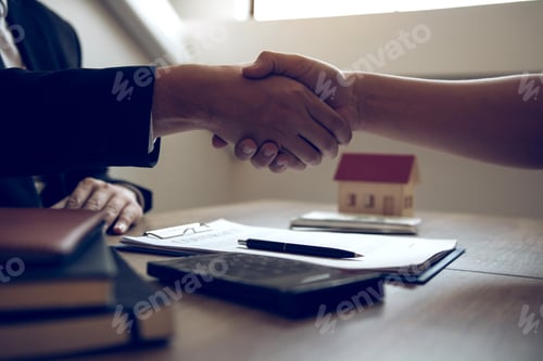 Preview: Home sales agents and buyers work on signing new homes and shaking hands.