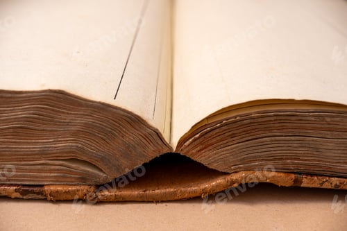 Preview: open books laying down on top of the ground with their covers folded
