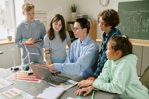 Preview: Multiethnic Teenagers Listening to Young Adult Teacher Explaining Project