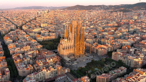 Preview: Aerial view of Barcelona Eixample residential district and Sagrada Familia Basilica at sunrise