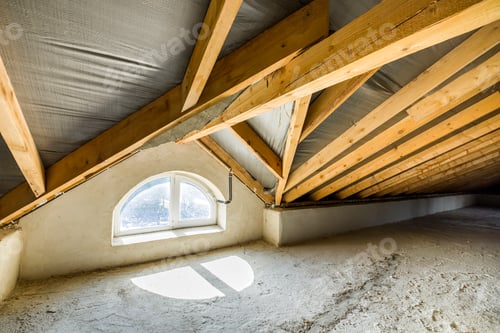 Preview: Attic of a building with wooden beams of a roof structure and a small window