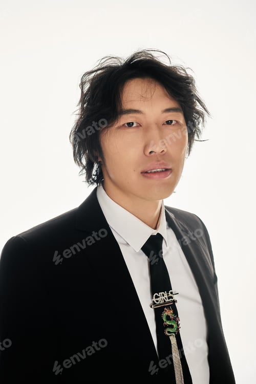Preview: Stylish young asian man showcasing contemporary elegance in a minimalist urban setting