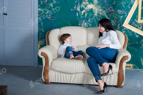 Preview: Beautiful woman and her cute little son are hugging and smiling. mom with a beautiful son