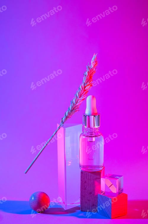 Preview: Bottle of cosmetic serum in neon light