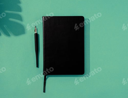 Preview: Minimal style black notebook and pens top view on green background, palm tree shadow overlay