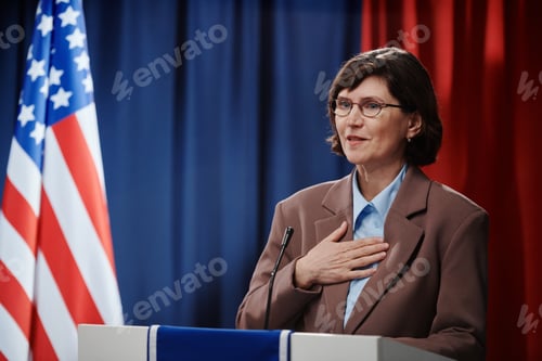 Preview: Mature politician keeping hand on chest
