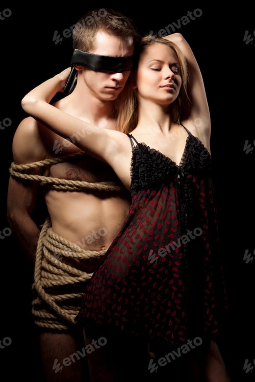 Preview: Woman embracing her man partner with naked body covered with ropes