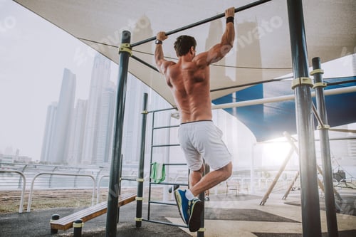 Preview: Beautiful man doing work out and different exercises outdoor