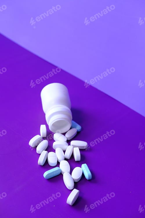 Preview: white pills spilling on purple background, Top view