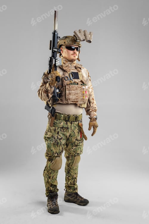 Preview: Soldier stands with weapon in tactical gear in a studio setting