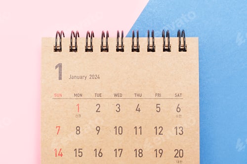 Preview: Brown calendar for 2024 on pink and blue background close-up, planning concept.