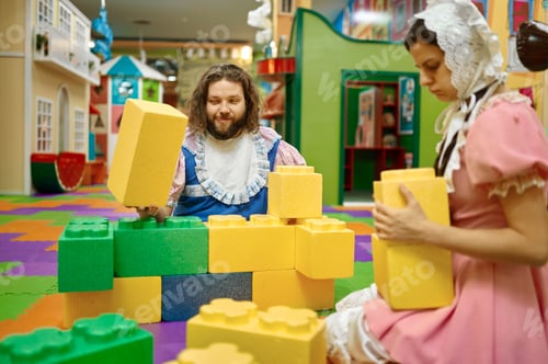 Preview: Funny man and woman like baby playing soft building blocks