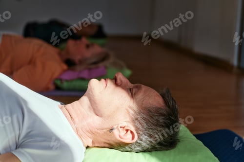 Preview: Senior woman practicing stretching and meditation on the floor, focusing on proper alignment and