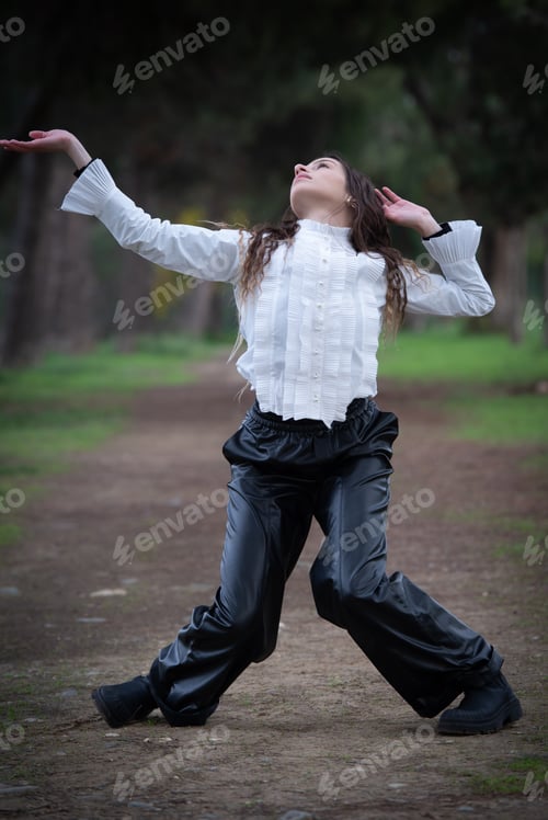 Preview: Young woman dancing outdoors. Dance performance in the street