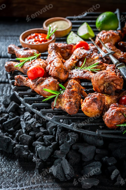 Preview: Hot roasted chicken leg served with red drip and lime.