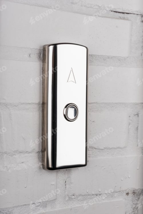 Preview: close up view of elevator button up direction on white wall