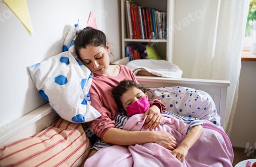 Preview: Tired mother looking after sick small daughter in bed at home, coronavirus concept