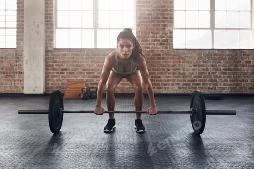 Preview: Female performing deadlift exercise with weight bar