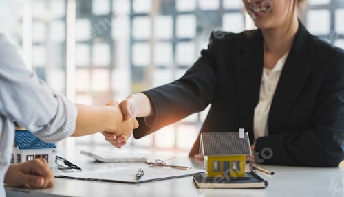 Preview: Successful deal Real estate lease or home purchase concept buyer shakes hands with bank employee aft