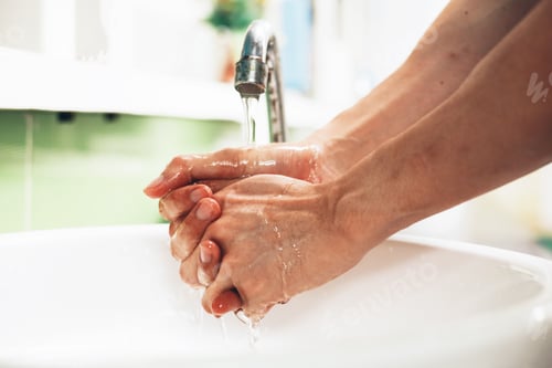 Preview: Close-up of human hands washing away germs and bacteria under the sanitary crane.
