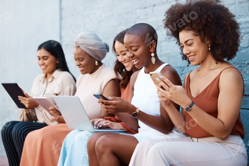 Preview: Group of five young happy cheerful businesswomen sitting on a bench against a wall outside in the c