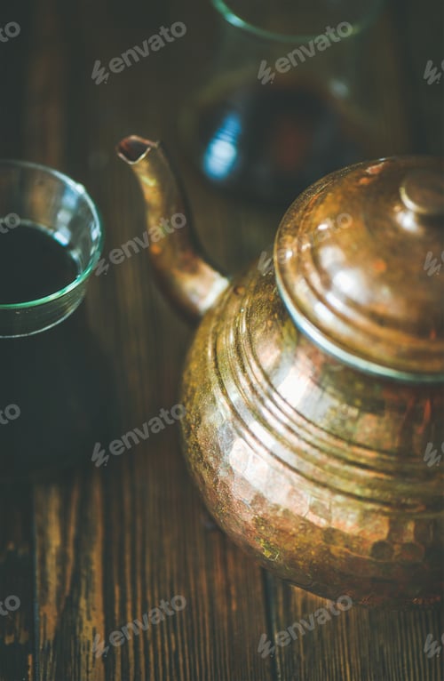 Preview: Oriental tea pot and black tea in tulip glasses