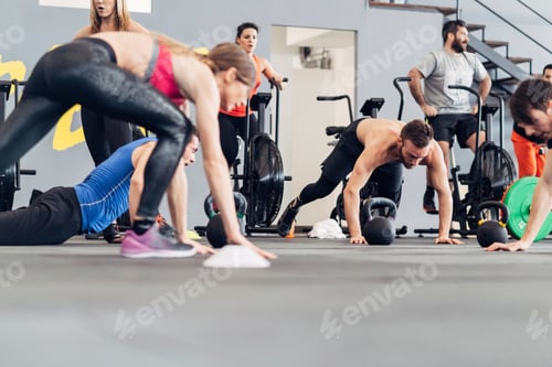 Preview: Medium group of people training in gym