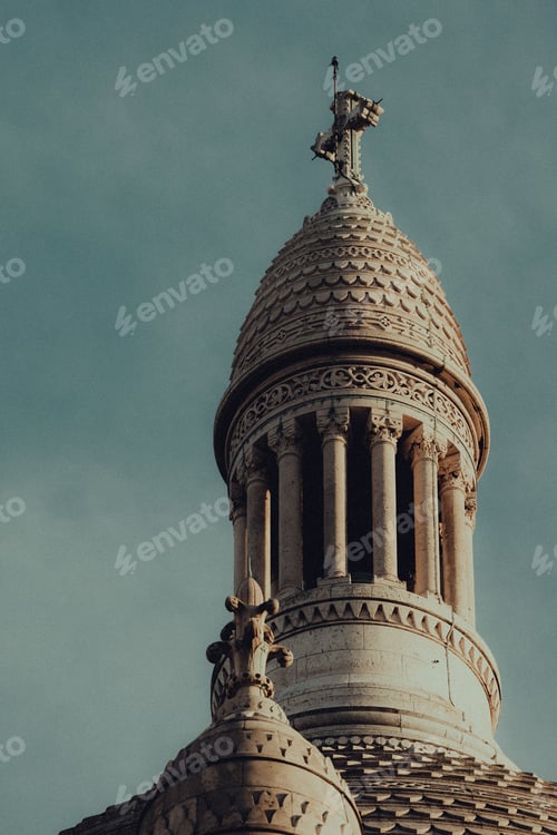 Preview: Close-up of the architectural details of Sacre-Coeur Basilica's dome against a blue sky in Paris