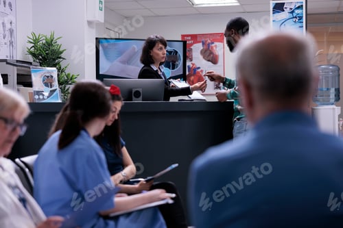 Preview: African american patient signing admission form into private clinic at hospital front desk