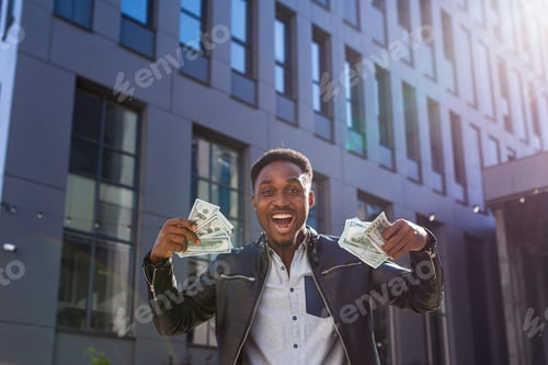 Preview: Successful businessman in casual clothes rejoices in success