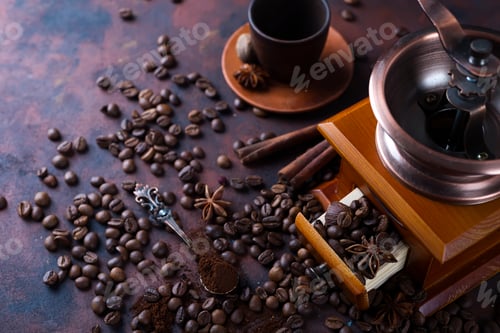 Preview: Old vintage grinder with roasted coffee beans and grind coffee on stone background.