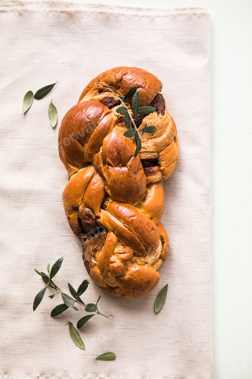 Preview: Tsoureki traditional baked Greek Easter sweet bread. Easter time, springtime. Holiday food concept.