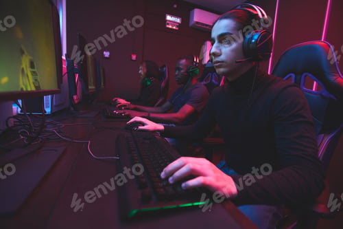 Serious Young Adults Playing Video Games Indoors