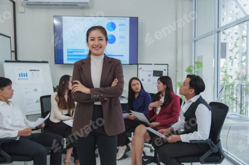 Preview: Confident businesswoman leading team meeting in office