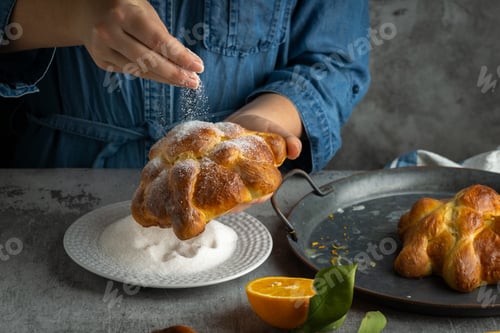 Preview: Woman preparing Pan de muertos bread of the dead for Mexican day of the dead