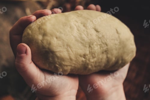 Doughy Delight: Soft Dough Held Tenderly in Hands