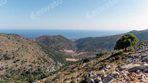 Preview: Mountain view of Crete coastline with clear sky and lush greenery