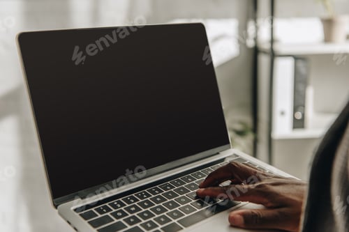 Preview: cropped view of african american businessperson using laptop with blank screen