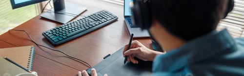 Preview: Male designer works in home office drawing on graphic tablet. Freelancer working on project