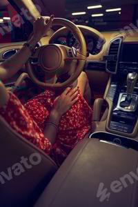 Preview: Woman sitting in car near gear shift lever
