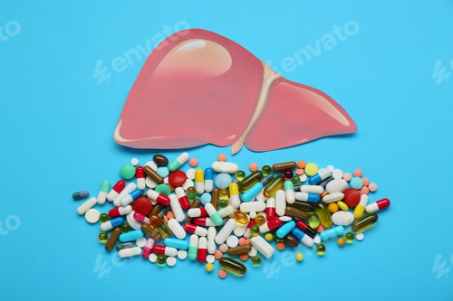 Preview: Paper liver and pills on light blue background, flat lay. Hepatitis treatment