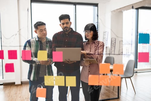 Preview: Team brainstorming session with sticky notes in modern office
