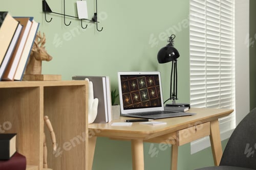 Preview: Workplace with modern laptop on wooden desk and bookcase at home