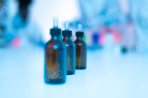 Preview: Bottles containing chemical liquid standing on laboratory table