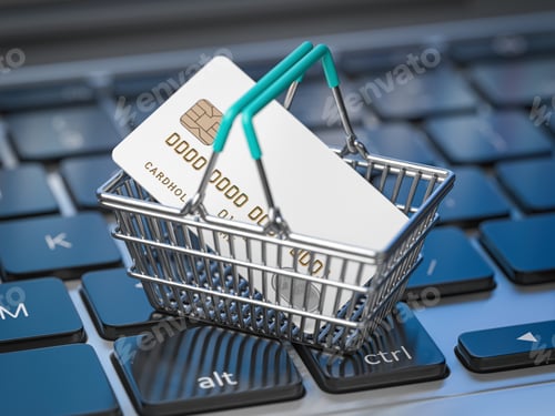 Preview: Shopping basket with credit card on laptop keyboard.