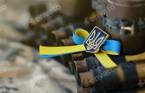 Preview: Ukrainian symbol on machine gun belt lies on ukrainian pixeled military camouflage