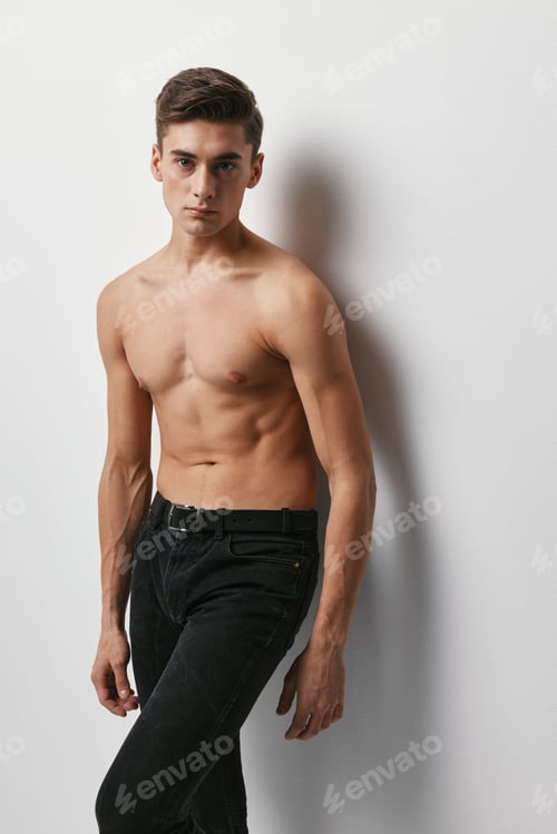 Preview: Handsome guy nude torso black pants light background