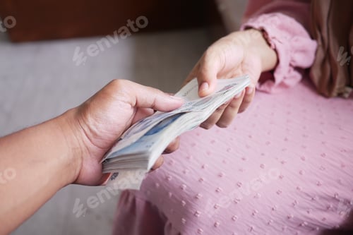 Preview: Close up of man hand giving us dollar cash