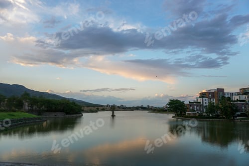 Preview: Peaceful view at the sky reflecting on the river by the town