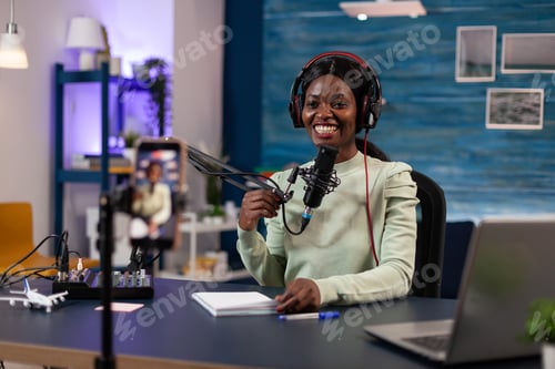 Preview: Podcast creator woman with headphones talking into production microphone